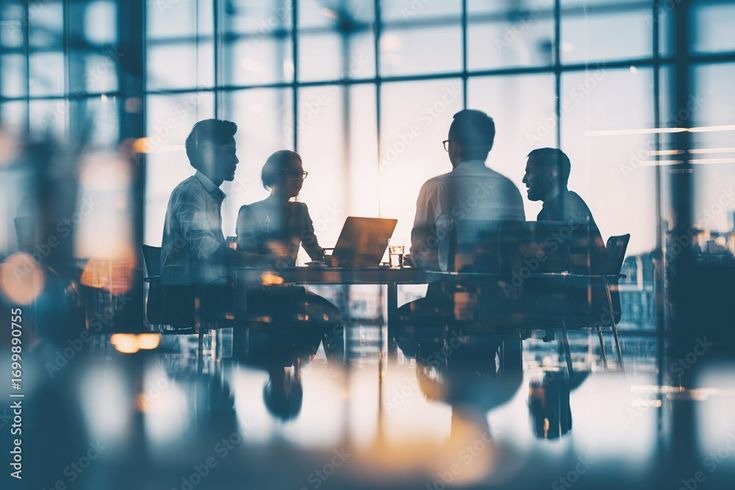 Silhouette of a professional team in a modern glass conference room